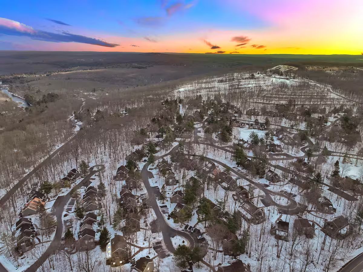 Sunset over snowy woods around Lake Harmony